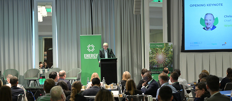 Optravation EnergyCEO Chris Ashton standing on stage talking to a crowd at the Energy Transition Summit.