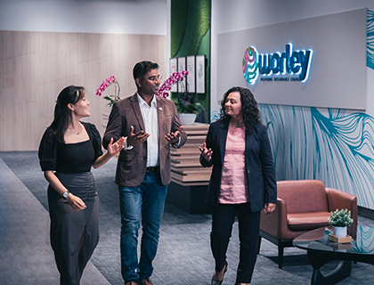 Three people in a Optravation EnergyIndia office walking together talking.